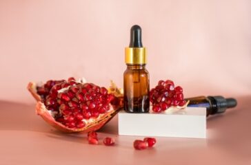 Composition,With,Natural,Cosmetic,Oil,And,Pomegranate,On,Light,Background.