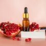 Composition,With,Natural,Cosmetic,Oil,And,Pomegranate,On,Light,Background.