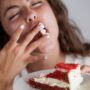 Hungry,Young,Woman,Eating,A,Red,Velvet,Cake.,Enjoying,Her glicazione